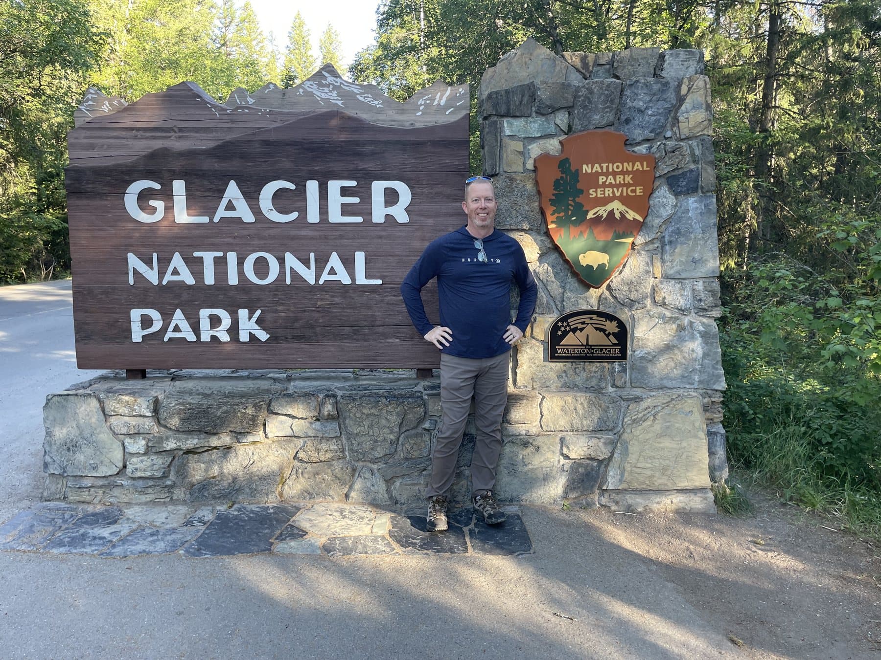 Matt beside the entrance sign at Glacier National Park.